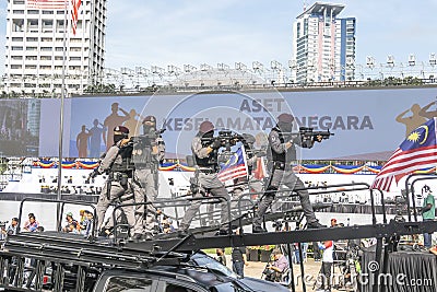 Malaysian Police's assault vehicle with VAT 69 Commando personnel during 65th Malaysia National Day in Kuala Lumpur. Editorial Stock Photo