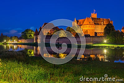 Malbork castle over the Nogat river at night, Poland Stock Photo