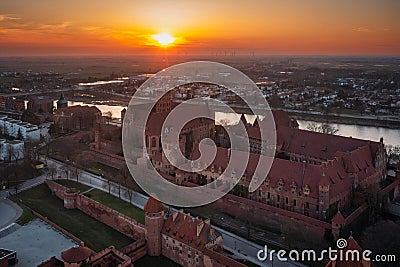 Malbork castle over the Nogat river at sunset, Poland Stock Photo