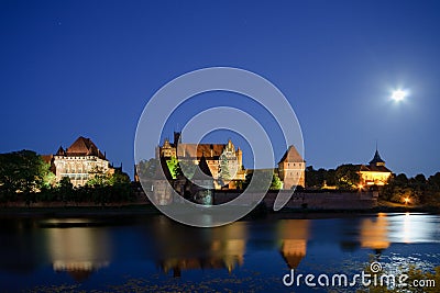 Malbork castle in Poland at night with reflection in Nogat river Stock Photo