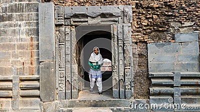 Malda, West Bengal, India - January 2018: A woman framed by stone door in the ruins of the ancient Adina Masjid mosque in the Editorial Stock Photo