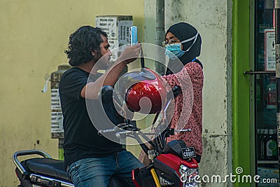 Maldivian young couple in masks at the street during corona virus pandemic Editorial Stock Photo