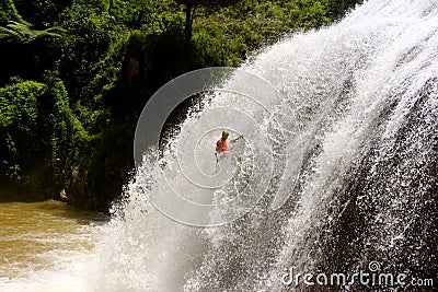 Male abseils massive waterfall Stock Photo