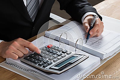 Male Accountant Calculating Tax Stock Photo