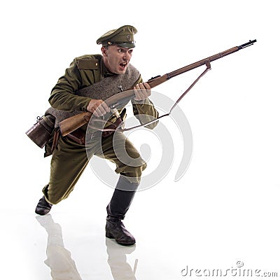 Male actor in the form of an ordinary soldier of the Russian army during the First World War posing against a white background in Stock Photo