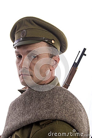 Male actor in the form of an ordinary soldier of the Russian army during the First World War posing against a white background in Stock Photo