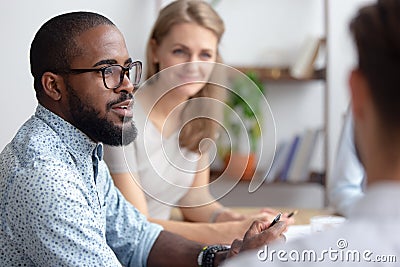 Male african-american talking to coworkers timeout in office Stock Photo