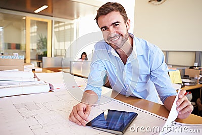 Male Architect With Digital Tablet Studying Plans In Office Stock Photo