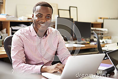 Male Architect Working At Desk On Laptop Stock Photo