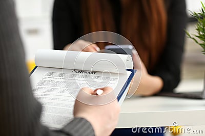 Male arm fill form clipped to pad with silver pen Stock Photo