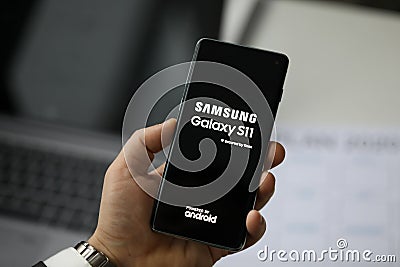 Male arm holding samsung galaxy s 11 Editorial Stock Photo