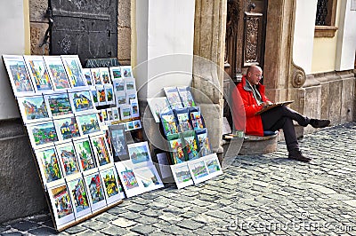 Male artist sales his paintings on the streets.Many street artists draw and sell paintings on street.Szentendre,Budapest Editorial Stock Photo