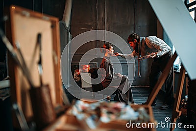 Male artist work with female poseur in art studio Stock Photo