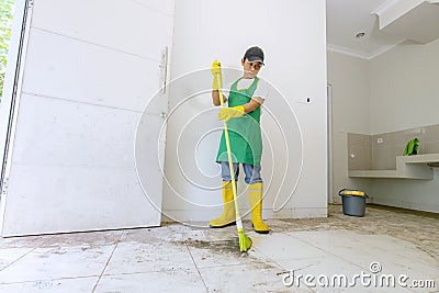 Male Asian worker cleaning dirty floor Stock Photo