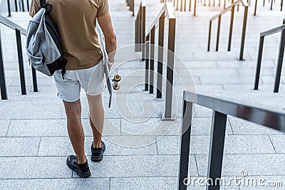 Man holding skate in hand at street Stock Photo