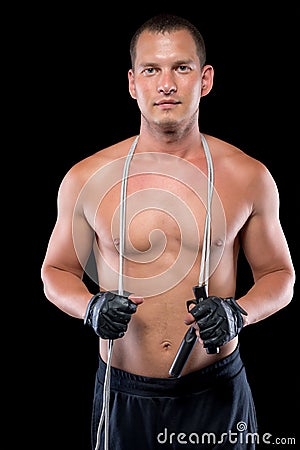 Male athlete with naked torso with gloves holding a rope Stock Photo