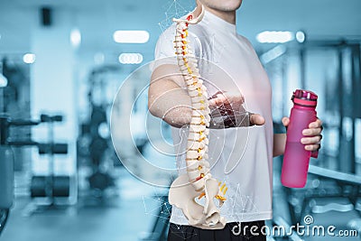 Male athlete shows a model of the spine Stock Photo