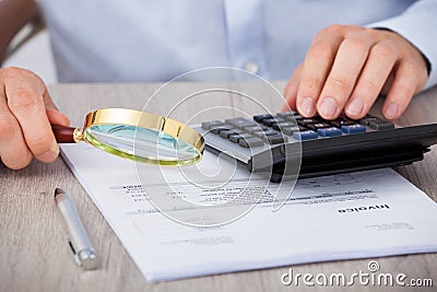 Male auditor scrutinizing financial documents Stock Photo