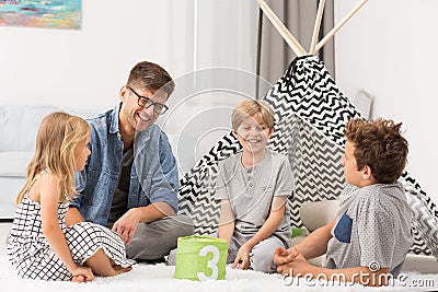 Male babysitter playing with children Stock Photo