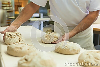 Male baker baking bread Stock Photo