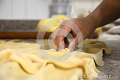 Male baker prepares cake in bakery Stock Photo