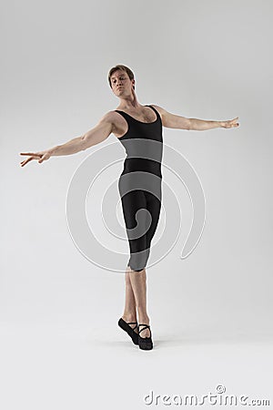 Male Ballet Dancer Flexible Athletic Man Posing in Black Tights in Ballanced Dance Pose With Hands Horizontal Stock Photo