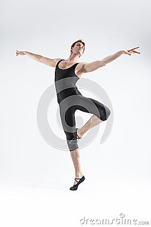 Male Ballet Dancer Flexible Athletic Man Posing in Black Tights in Ballanced Dance Pose With Hands Lifted Stock Photo