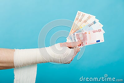 Male bandaged hand with money. Stock Photo