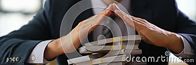 Male banker protecting with hands lot of banknotes closeup Stock Photo