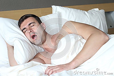 Male in bed with sleep apnea disorder Stock Photo