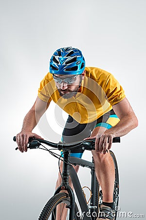 The bicyclist on gray, studio shot. Stock Photo