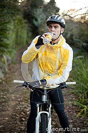 Male biker drinking water Stock Photo