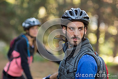 Male biker in forest Stock Photo