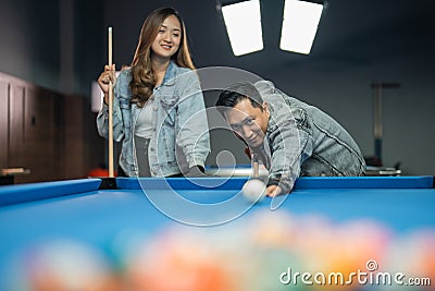 male billiard player poking the white ball for starting the game Stock Photo