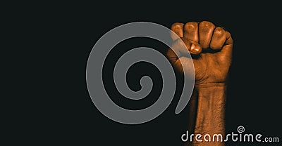 Male black fist on a black background. Aggressiveness, masculinity, the concept of challenge Stock Photo