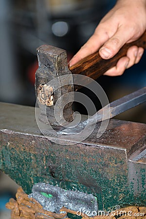 Male blacksmith in his smithy workshop Stock Photo