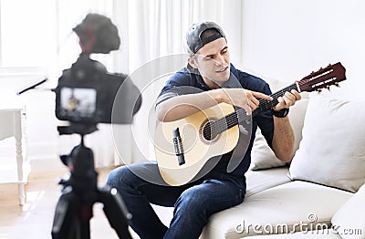Male blogger recording music related broadcast at home Stock Photo