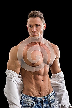 Male bodybuilder opening his shirt revealing muscular torso Stock Photo