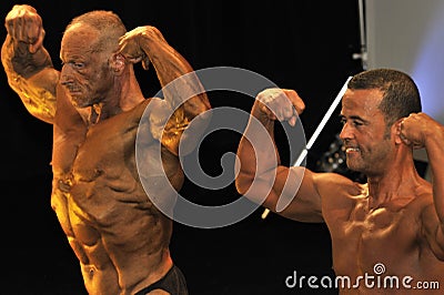 Male bodybuilding contestant showing his best Editorial Stock Photo