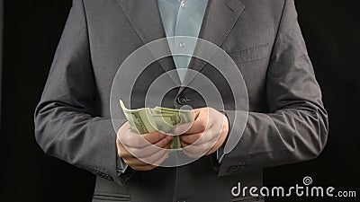 Male boss counting dollars, money making, economy, income from personal project Stock Photo