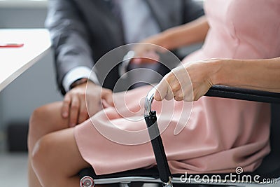 Male boss at work in the office touches the woman& x27;s leg Stock Photo