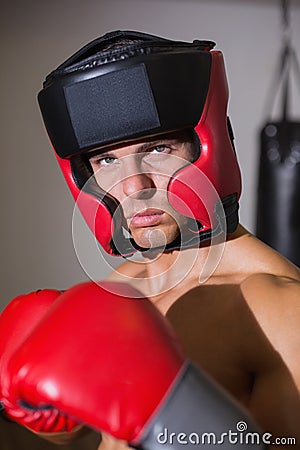 Male boxer in defensive stance in health club Stock Photo