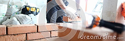 Male builder hand in gloves holding Stock Photo