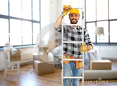 male builder in helmet climbing up ladder at home Stock Photo