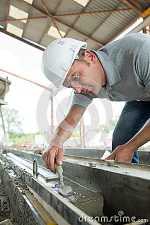 Male builder working with cement outdside factory Stock Photo