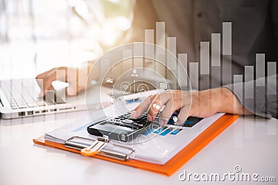 Male businessman calculates financials with graph paper. Stock Photo