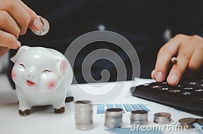 Male businessman use calculator money coin financial tax and planning investments marketing economy income and retirement saving Stock Photo