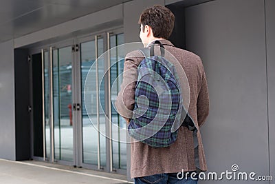 Male businessperson walking in modern city district Stock Photo