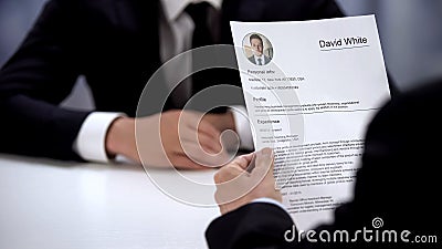 Male candidate presenting CV to HR manager at job interview, first impression Stock Photo