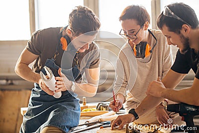 Carpenter Training Female Apprentice To Use Plane Stock Photo